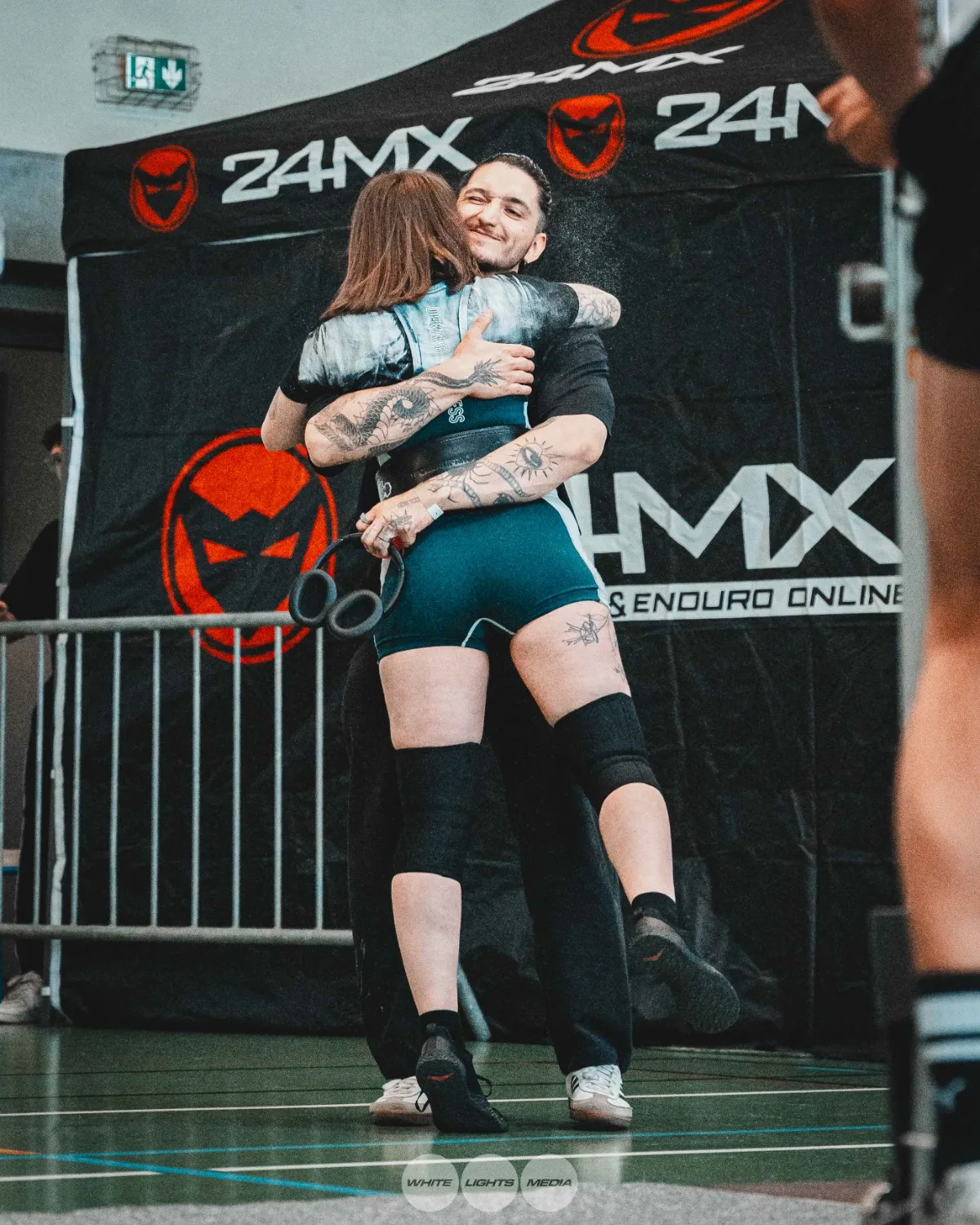 Hug between Atlas Coaching athletes