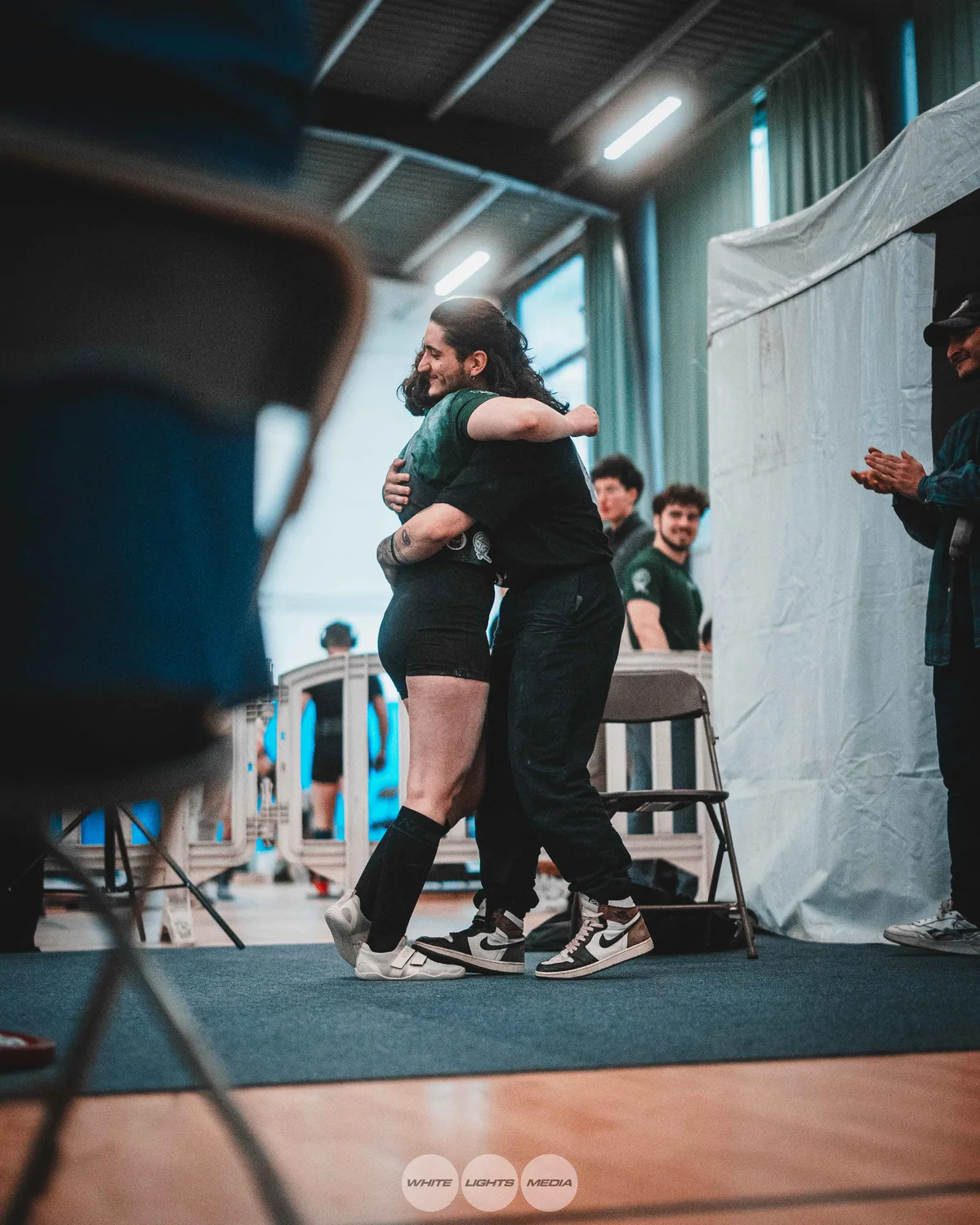 Hug between Atlas Coaching athletes