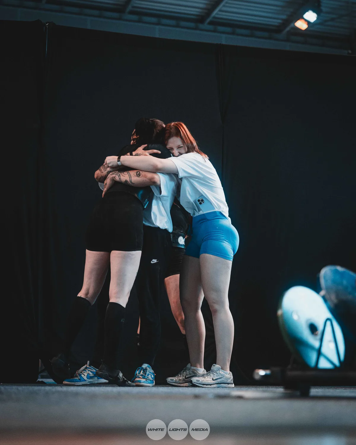 Hug between Atlas Coaching athletes