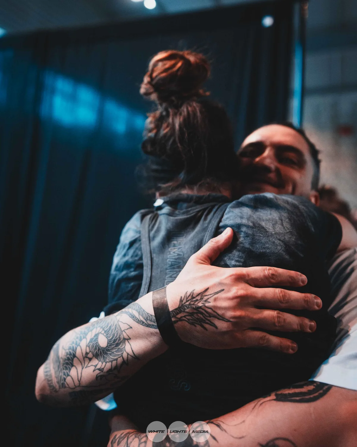 Hug between Atlas Coaching athletes