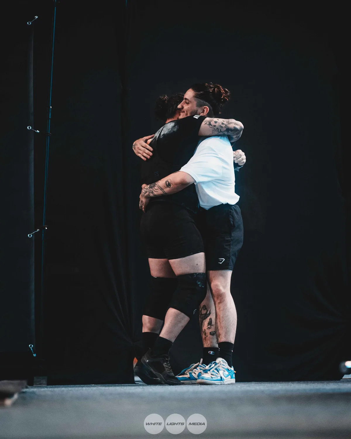 Hug between Atlas Coaching athletes