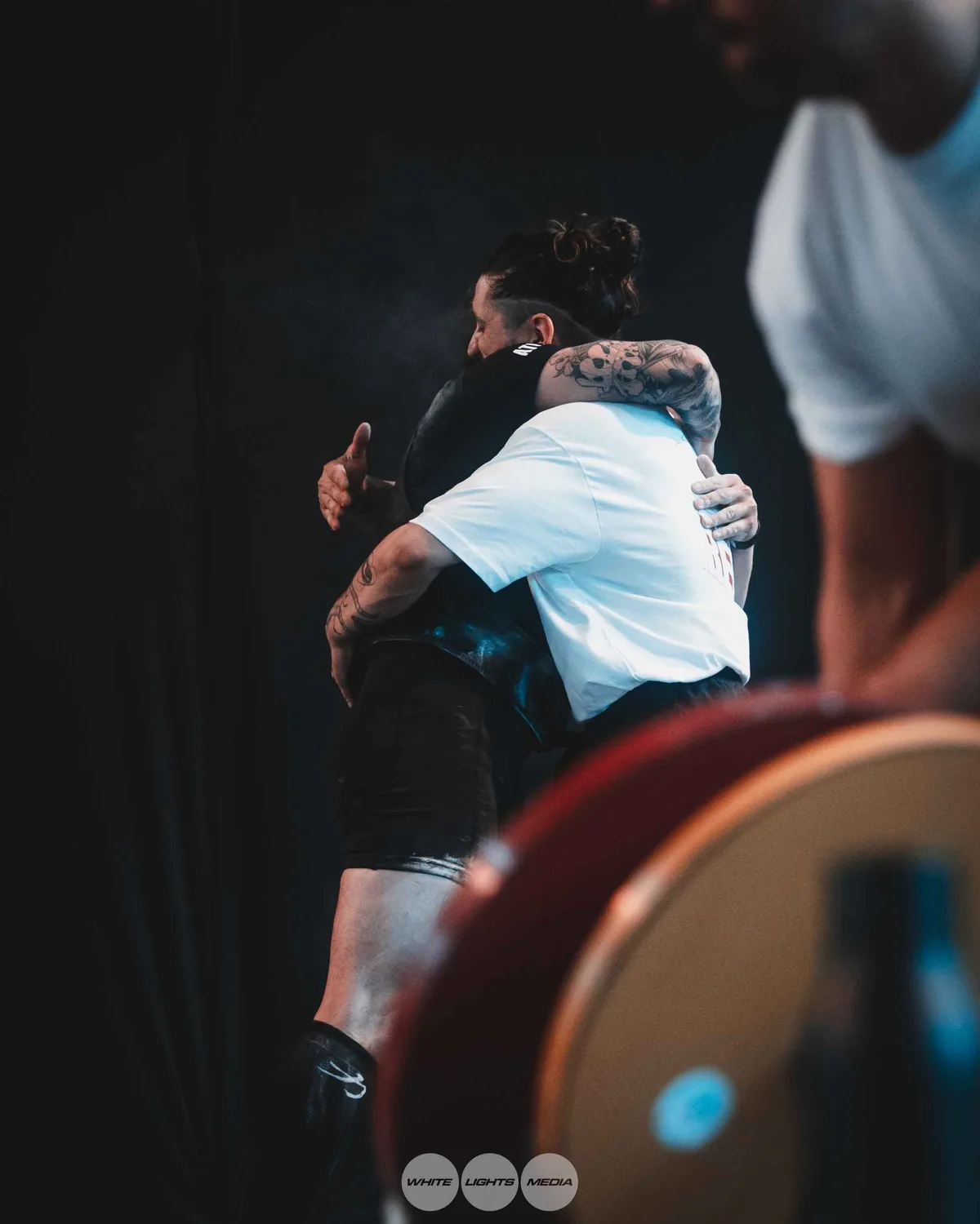 Hug between Atlas Coaching athletes