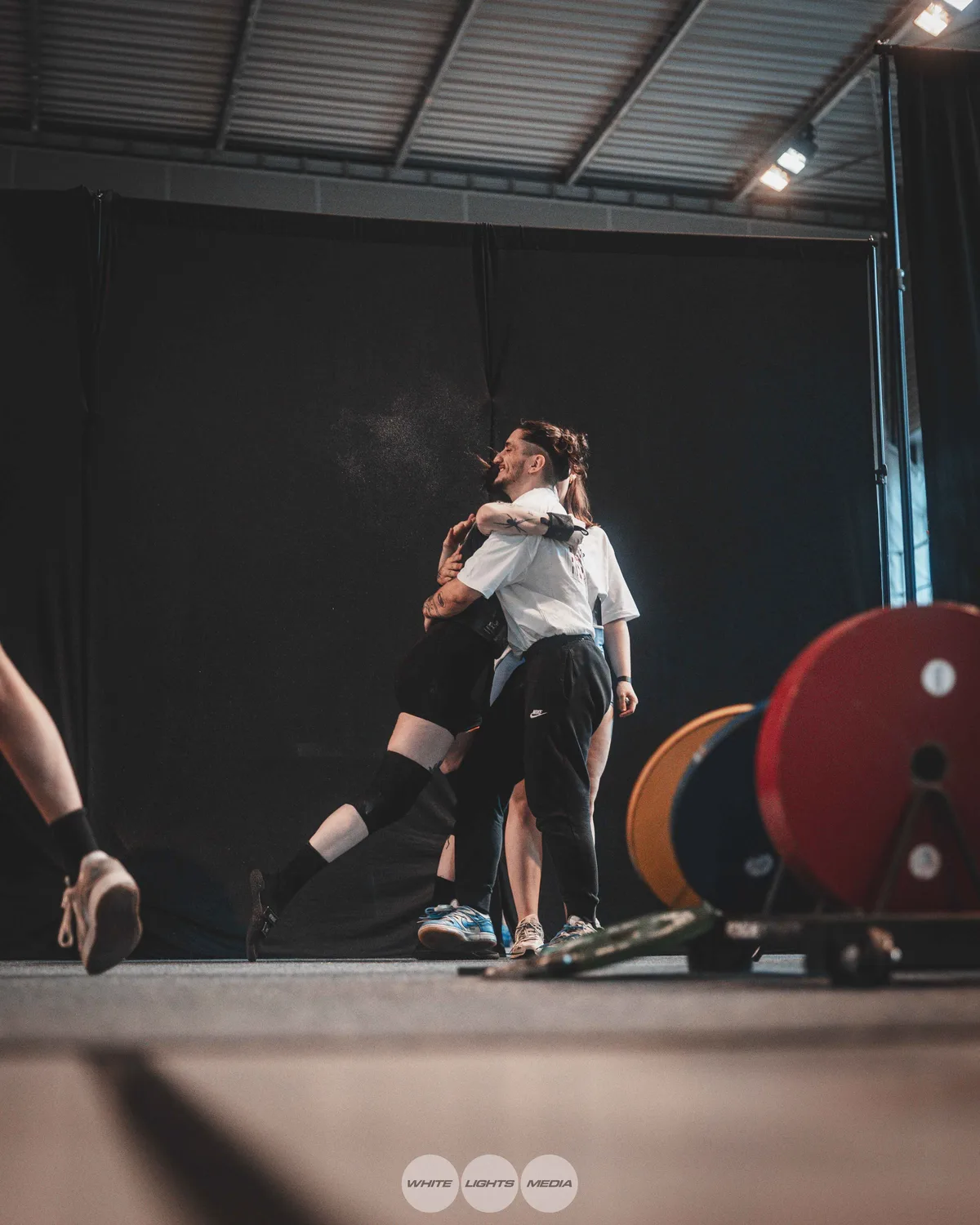 Hug between Atlas Coaching athletes