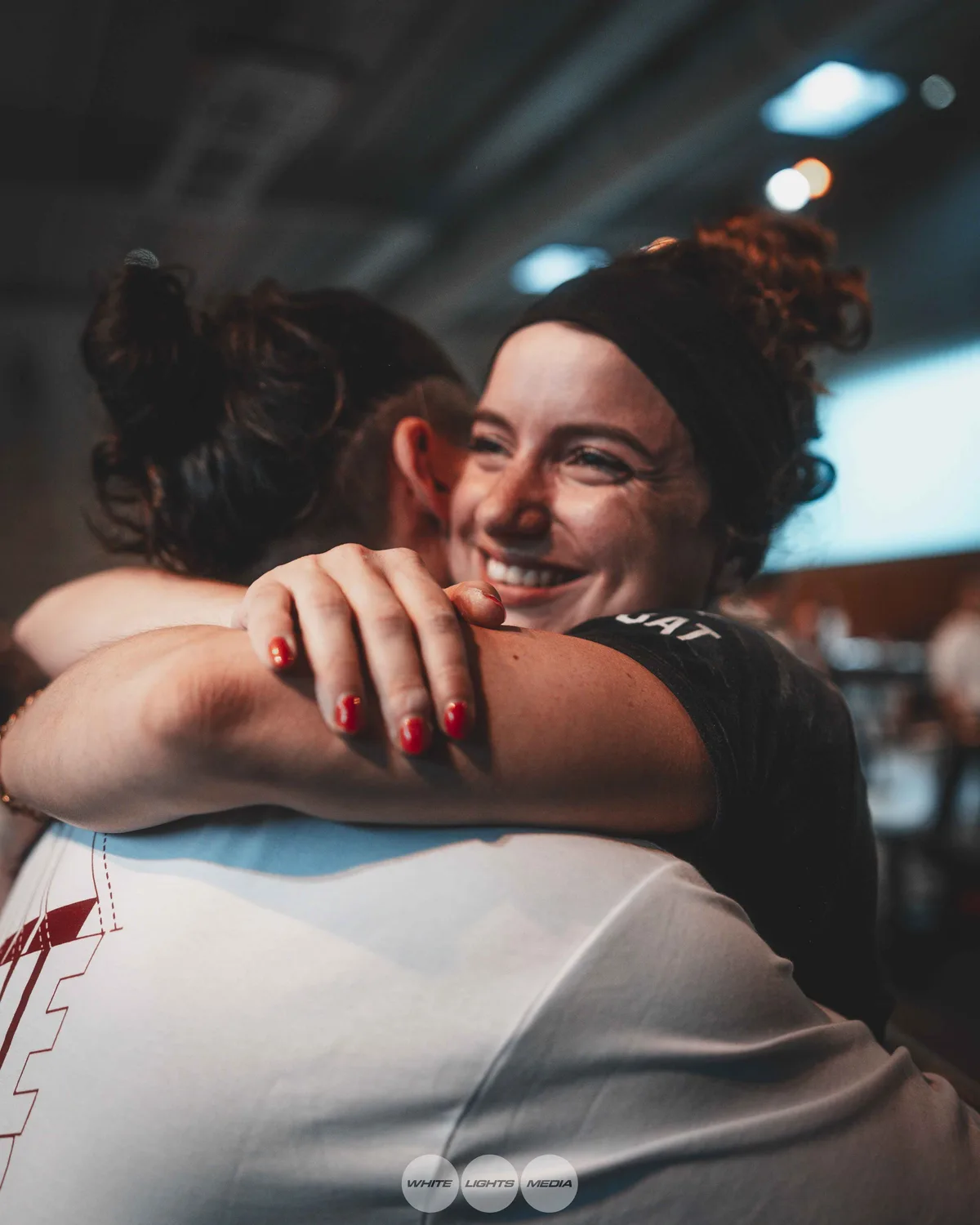Hug between Atlas Coaching athletes