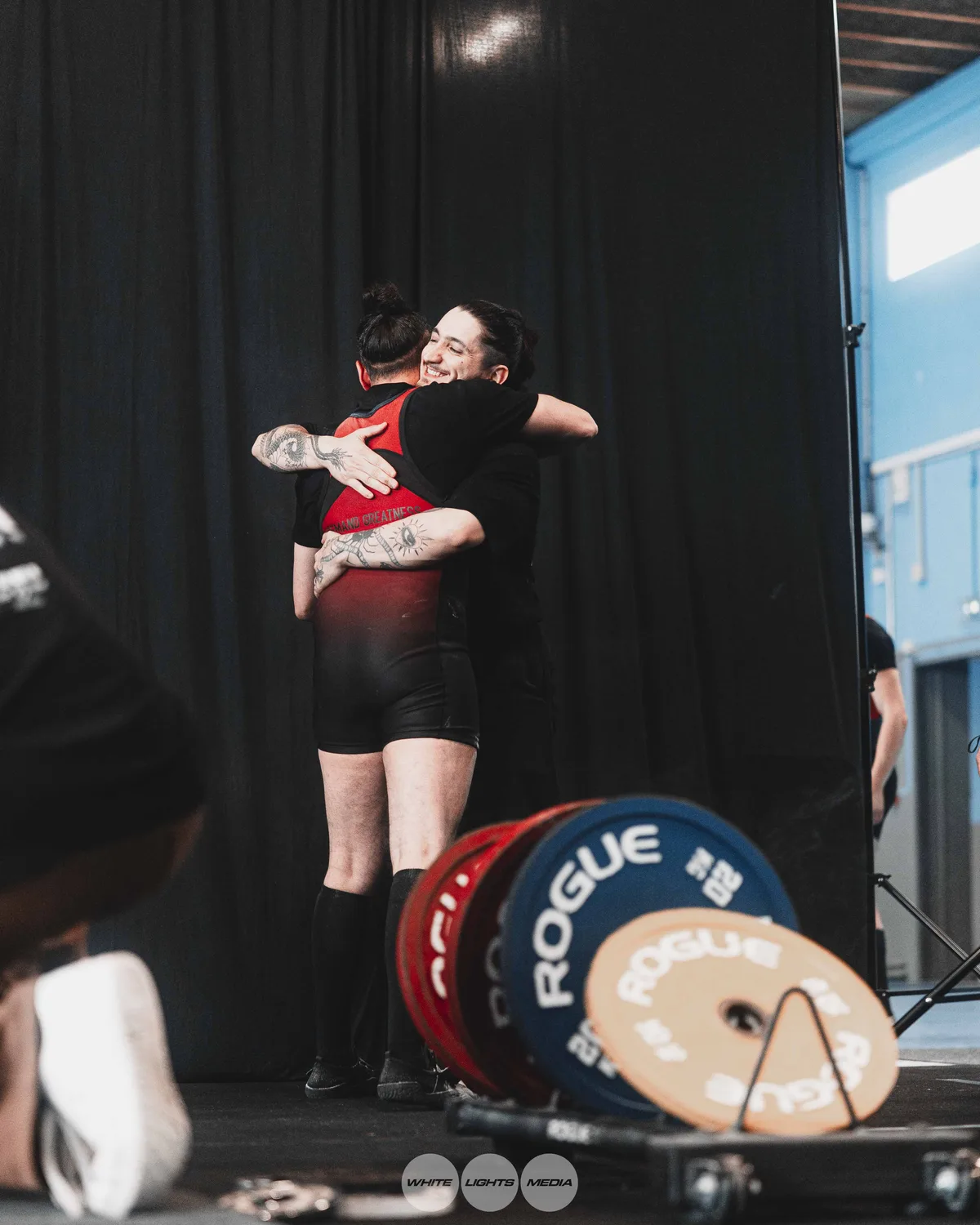 Hug between Atlas Coaching athletes